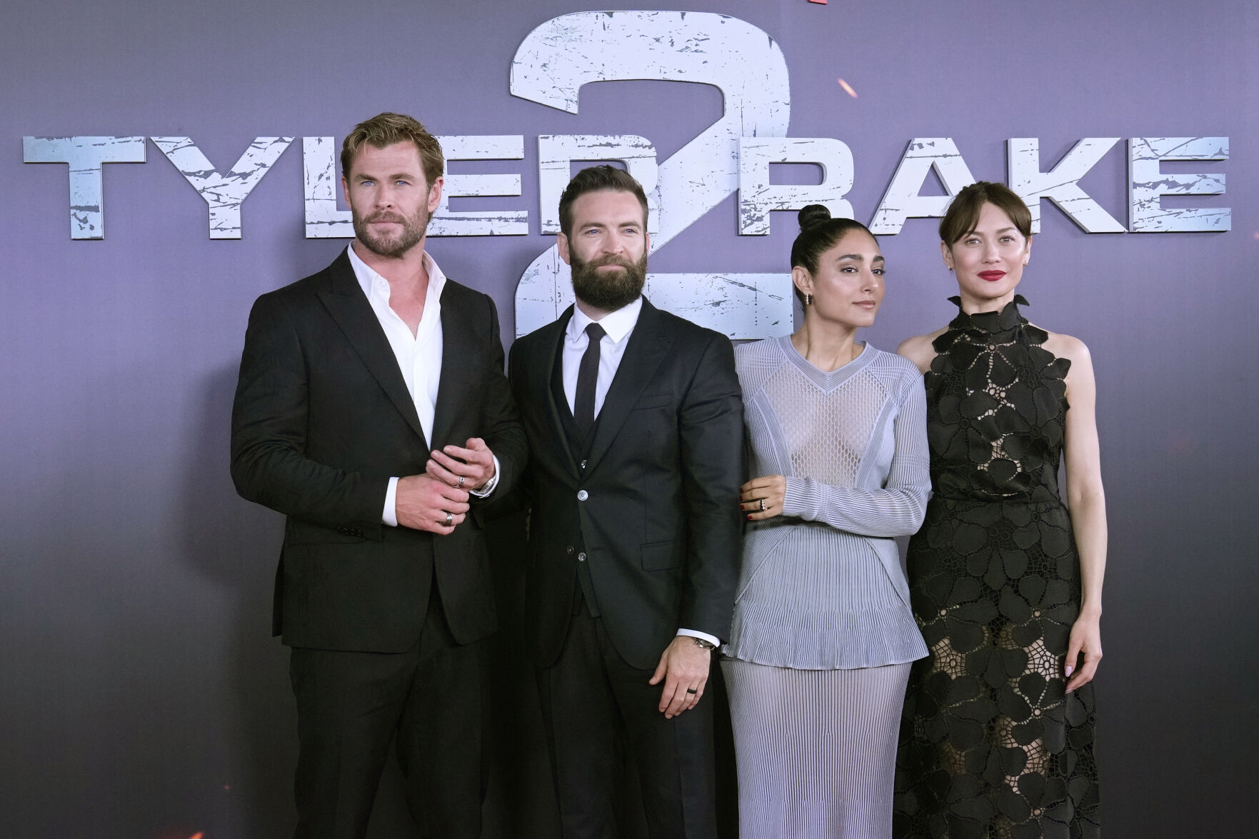 Actor Chris Hemsworth, left, poses with Director Sam Hargrave, 2nd left, Golshifteh Farahani, 3rd left and actress Olga Kurylenko, right, during the Extraction 2 movie premiere in Madrid, Spain, Wednesday, June 7, 2023.