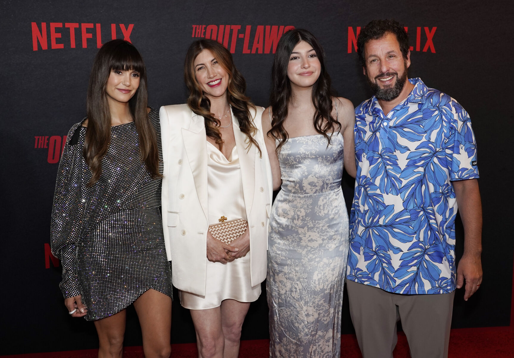Adam Sandler, right, poses with, from left, actor Nina Dobrev, his wife Jackie and their daughter Sunny