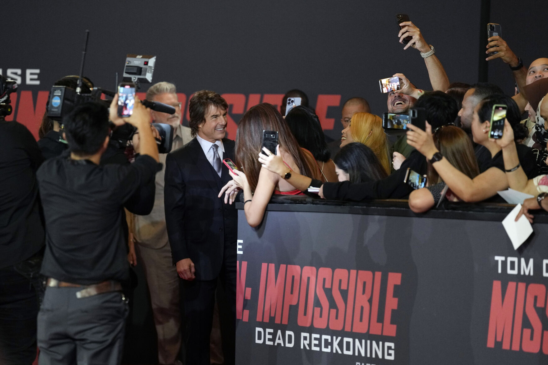 Tom Cruise talks to his fans at the premiere of the film "Mission Impossible, Dead Reckoning Part One" at the Emirates Palace in Abu Dhabi, United Arab Emirates, Monday, June 26, 2023.